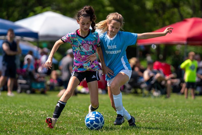 Two girls fight for the ball during the 3v3 Soccer Tournament.